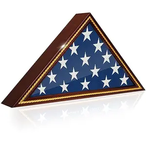 Mahogany triangular flag display case with glass front, hanging on a wall with a folded burial flag inside.
