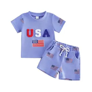 Toddler boy wearing waffle knit USA flag embroidered shirt and shorts set